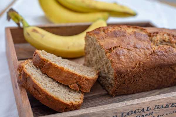 Banana Bread Day. Load of banana bread on a tray with bananas in the background