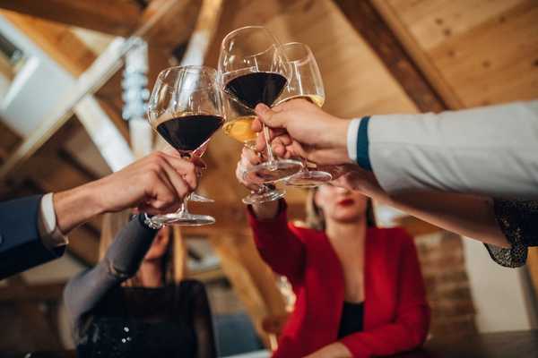 Global Drink Wine Day. People holding glasses of wine and clinking glasses - cheers!