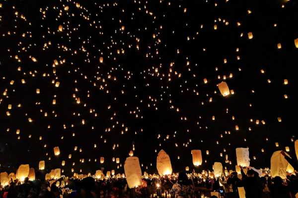 Lantern Festival. Lanterns floating in the sky and in water in the dark