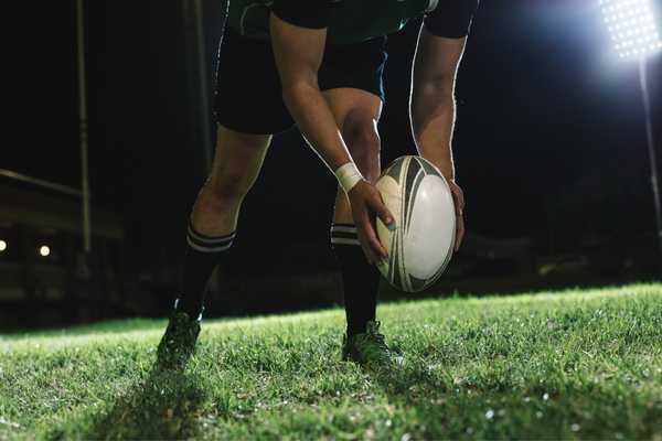 Man with rugby ball for Army vs Navy Rugby