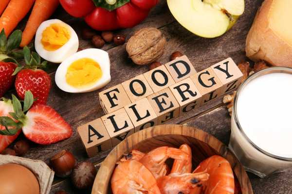 Food allergy sign with different foods surrounding it for Food Allergy Awareness Week