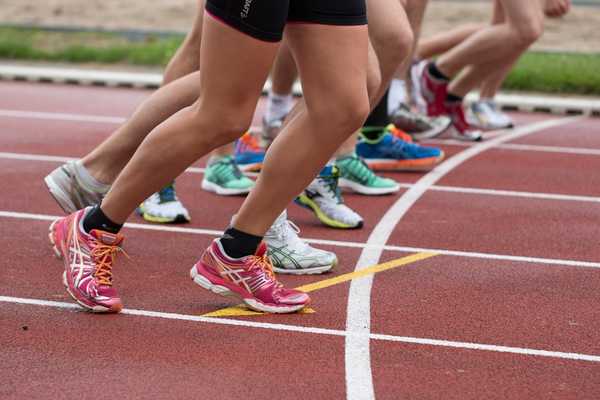 Runners starting off on a running track for Global Running Day