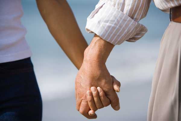 Man and woman holding hands for Husband Appreciation Day