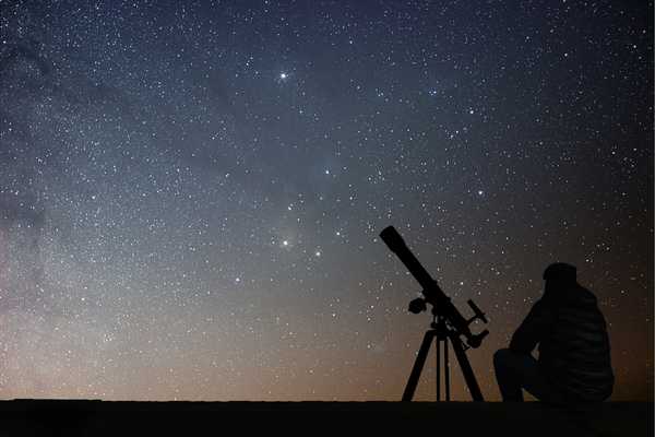 Telescope against backdrop of night sky for International Astronomy Day