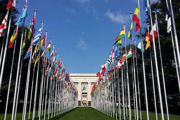 United nations building in Geneva with flags for International Day of United Nations Peacekeepers