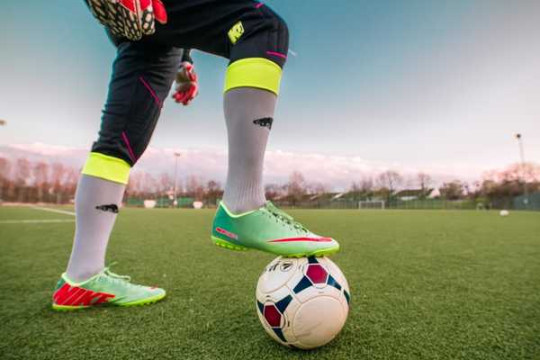 Lady with foot on football for Women's FA Cup Final