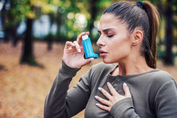 A lady taking an inhaler for World Asthma Day