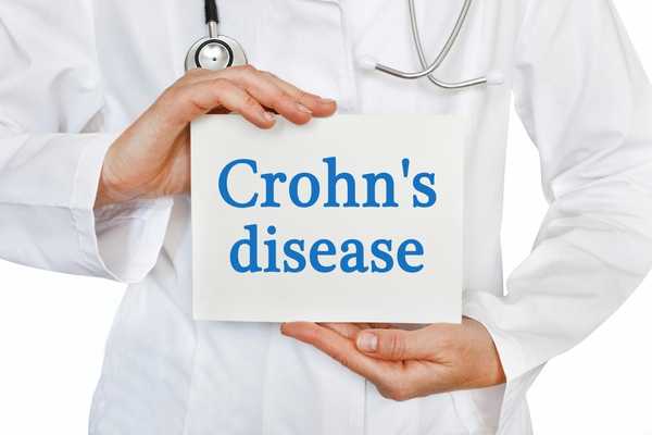 Doctor with a sign saying Crohn's disease for World IBD Day (Crohn's Disease)