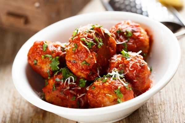 Bowl full of meatballs in tomato sauce for National Meatball Day