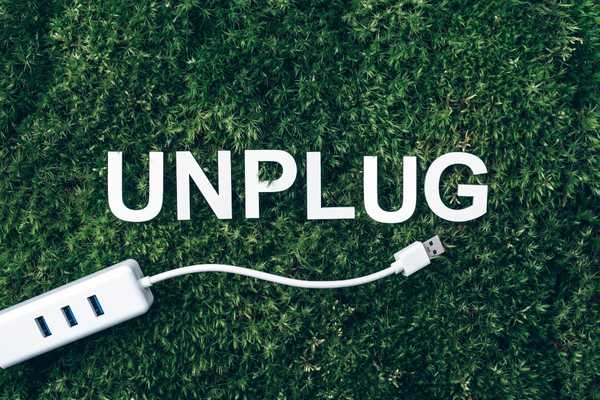 The word UNPLUG with a picture of a computer lead below it for National Unplugging Day