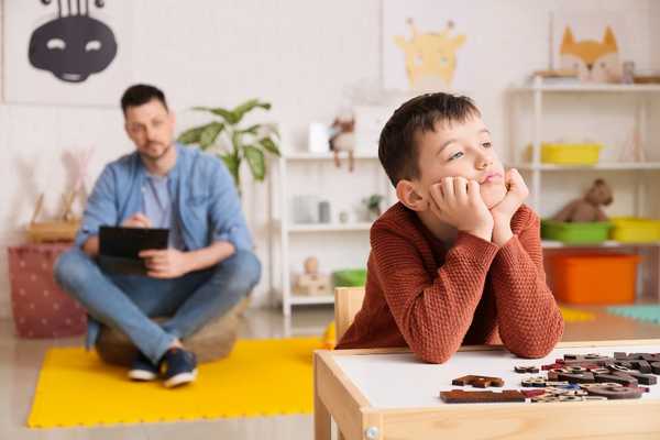 Father and son in room, the boy looking away from his father for World Autism Acceptance Week