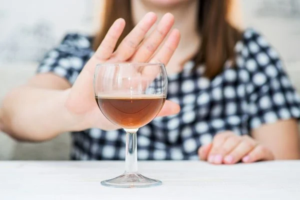 Person pushing a glass of wine away for Alcohol Awareness Week