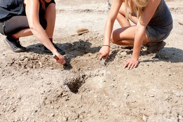 Two people digging in the ground for Festival of British Archaeology