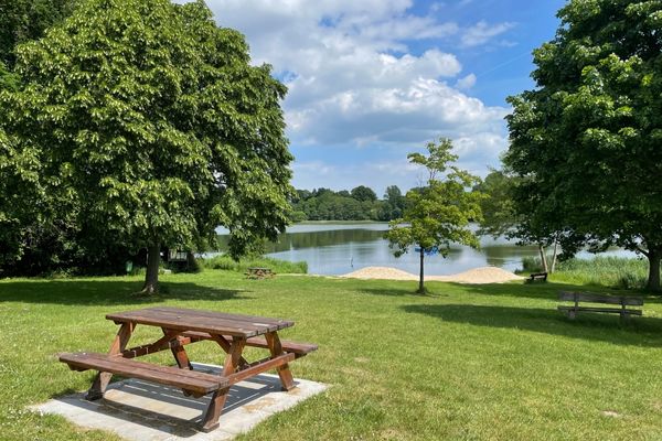 Picnic table in a park overlooking a small lake for Love Parks Week