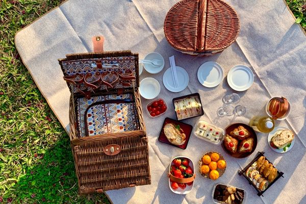 Picnic spread of food on a blanket for National Picnic Month
