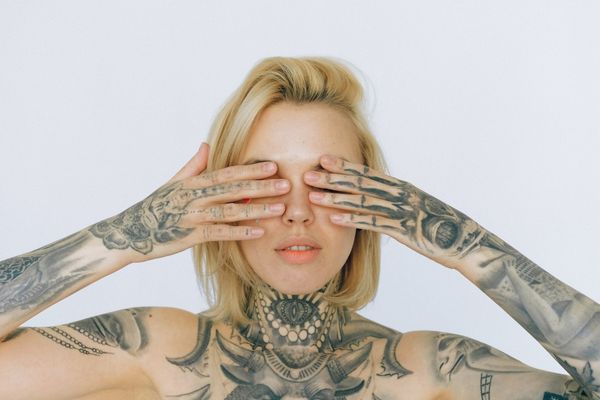 Lady with tattoo covering her eyes for Tattoo Day