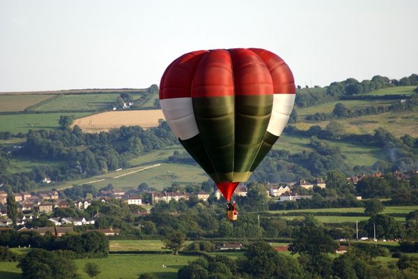 Hot air balloon flying above the English countryside for Bristol International Balloon Fiesta