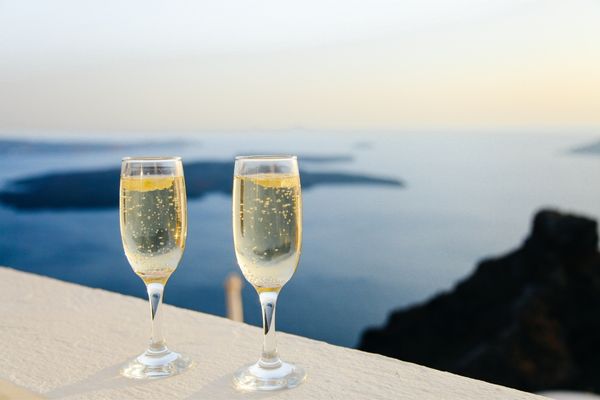 Two glasses of prosecco on a bar overlooking the sea for National Prosecco Day