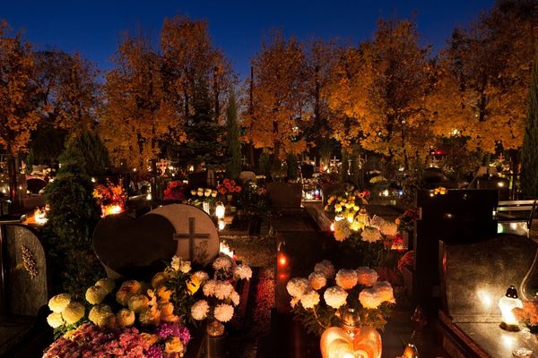 Candles lighting up a graveyard for All Saints Day