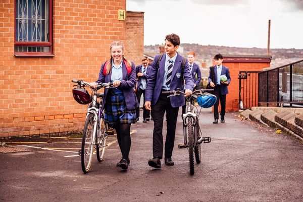 School children pushing bikes for Bike to School Week