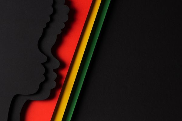 Side profile silhouette against a black background with red, yellow and green stripes for Black History Month