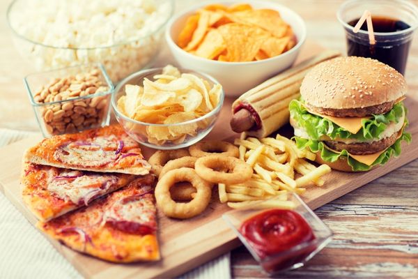 Array of fast food including pizza, burgers, crips and onion rings for Fast Food Day