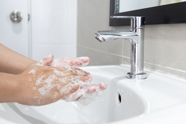 Person washing their hands under a tap for Global Handwashing Day