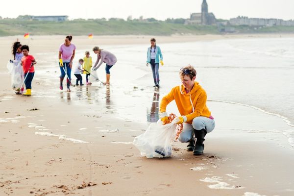 Group of people collecting litter on a beach for the Great British Beach Clean