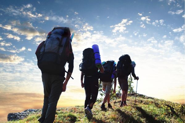 Group of people walking with backpacks for Hiking Day