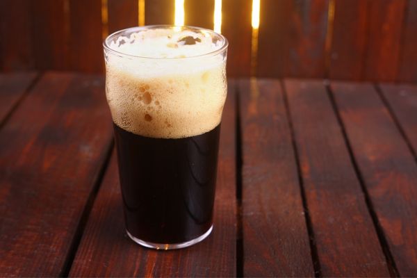 Half full glass of stout for International Stout Day