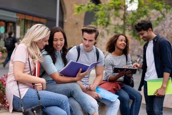 Group of students holding books for International Students Day