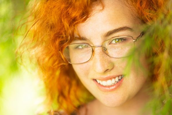 Woman with curly red hair for Love Your Red Hair Day
