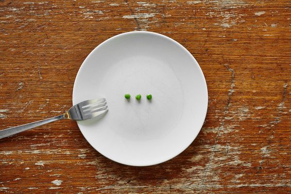 Fork and white plate with three peas for Malnutrition Awareness Week