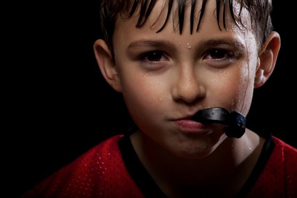 Boy wearing black mouthguard for Mouthguard Day