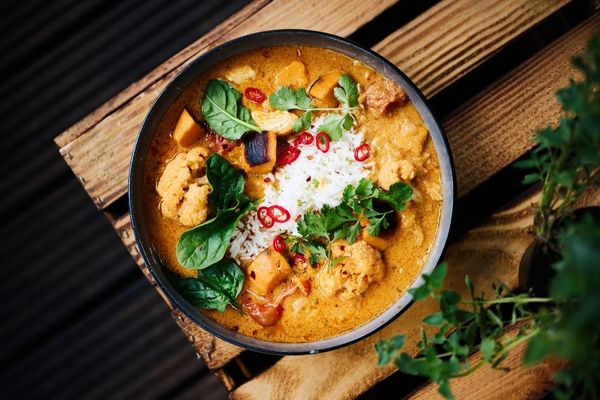 Bowl of curry on a wooden table for National Curry Week