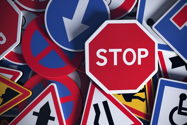 Array of road signs with a prominent "Stop" sign for Road Safety Week