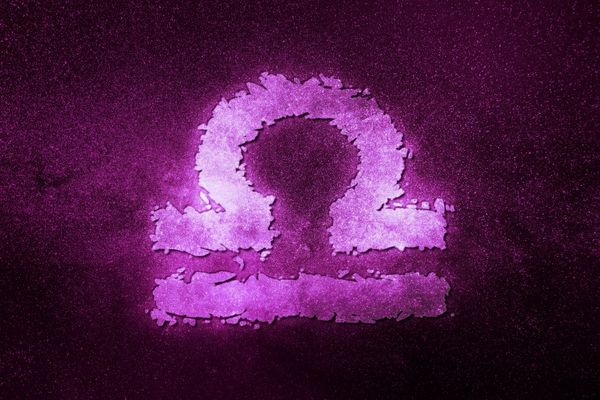 Purple Libra symbol on a black background for Start Date for Libra