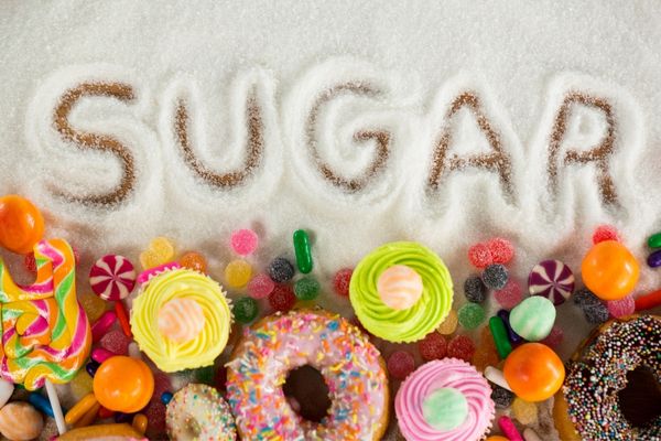 The word "sugar" spelled out in sugar with sweet treats for Sugar Awareness Week