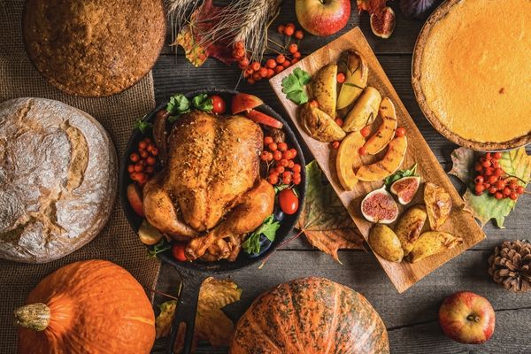Array of foods on a table including a large turkey for Thanksgiving