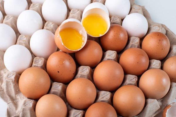 Array of white, brown and cracked eggs for World Egg Day