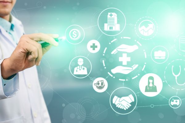 Doctor pointing to a board of medical symbols for World Patient Safety Day