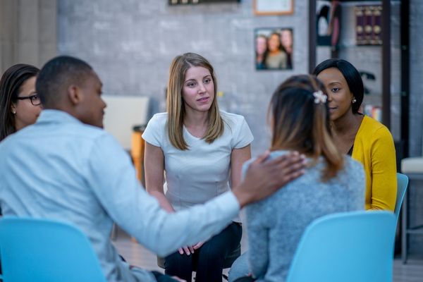 Group of young people sitting in a circle for Youth Mental Health Day