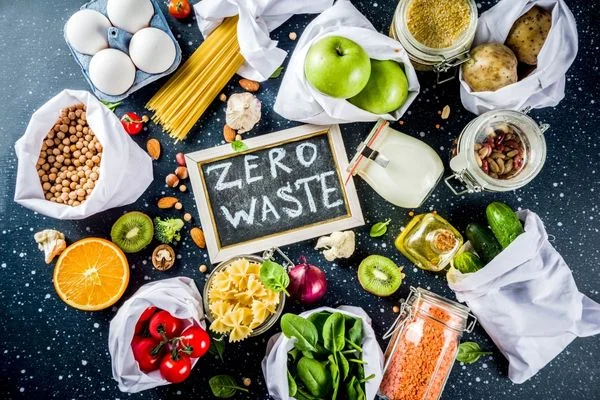 Array of fruit and vegetables on a table with a blackboard reading 'Zero Waste' for Zero Waste Week