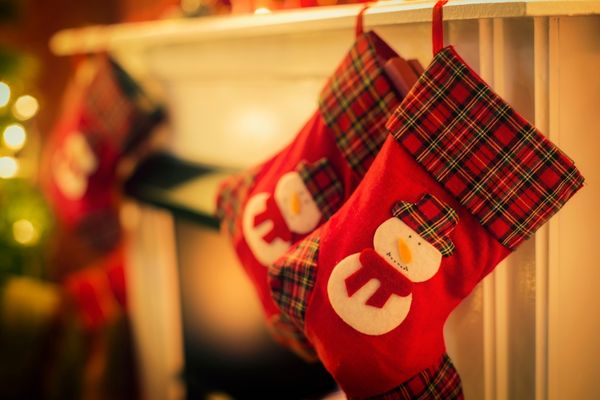 Two stockings hanging on a fireplace for Christmas Eve