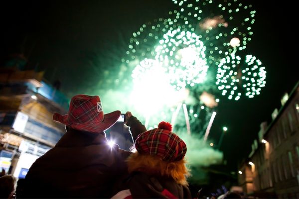 Couple watching fireworks for Hogmanay in Scotland