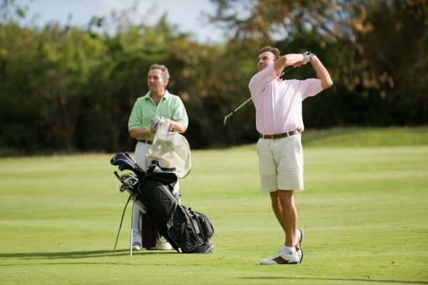 Two people playing golf for Golf Lovers Day on 4th October