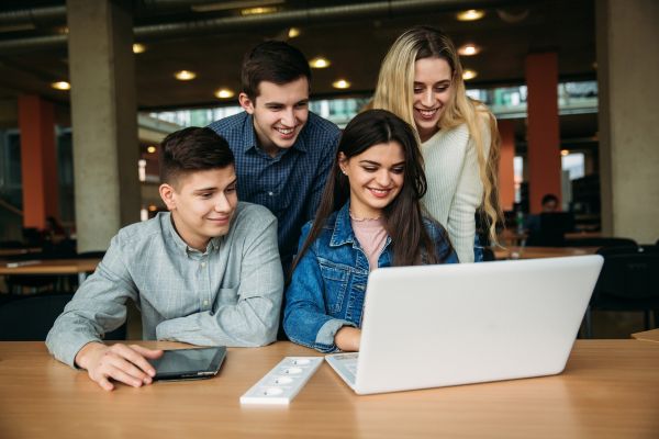 Students around a laptop for World Students' Day on 15th October