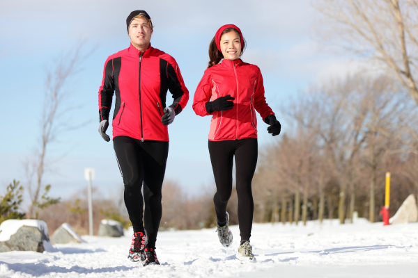People running in the snow with red tops on for red January