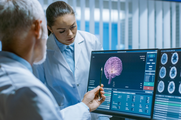 2 health professionals looking at an image of a brain for World Brain Day