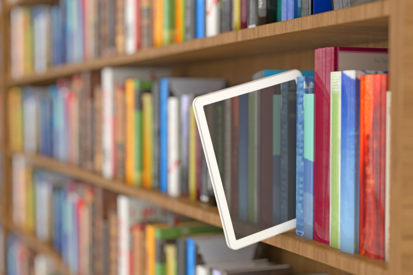 Tablet poking out of a bookshelf for Read An E-Book Week in March